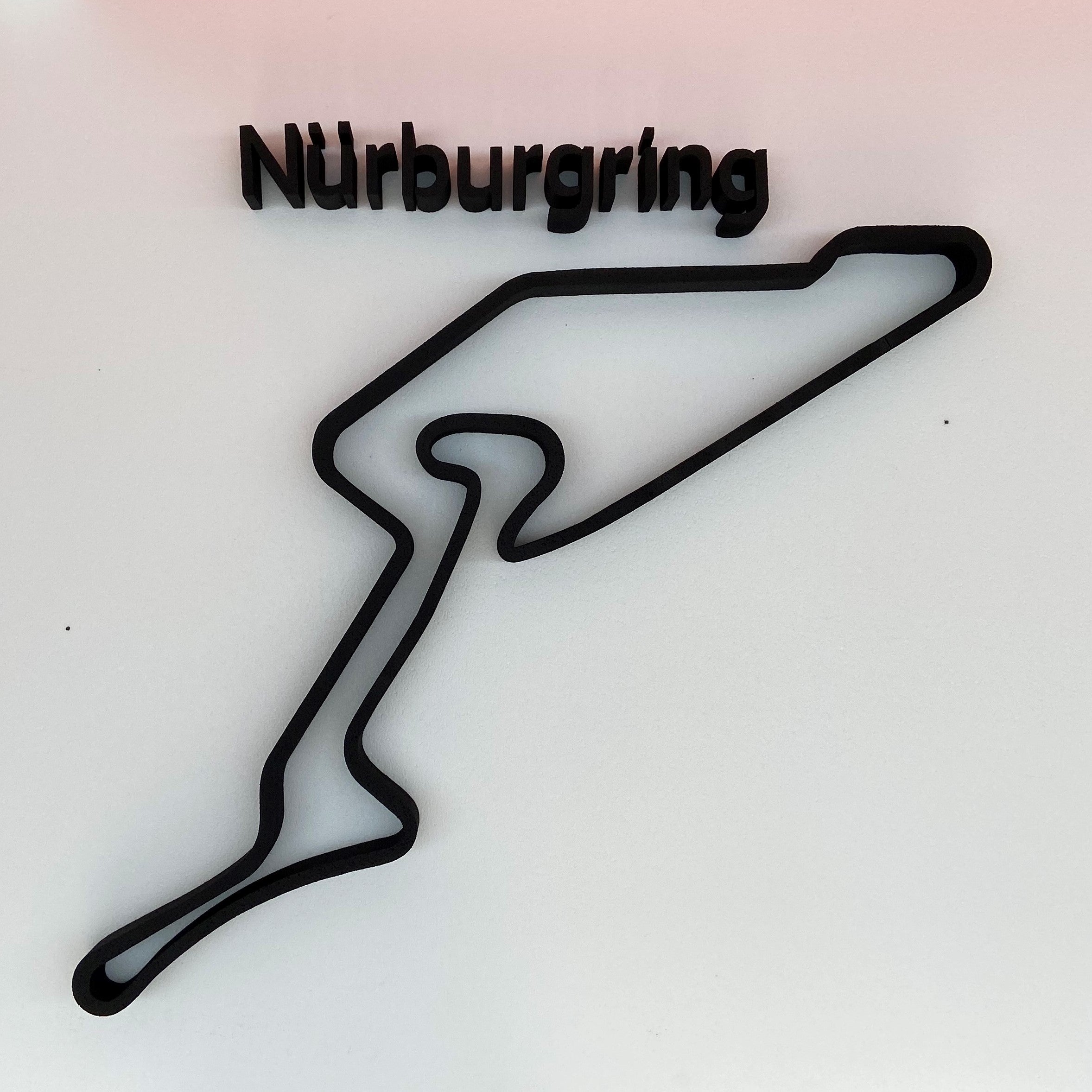Black outline of the Nörburgring racetrack on a light gray background